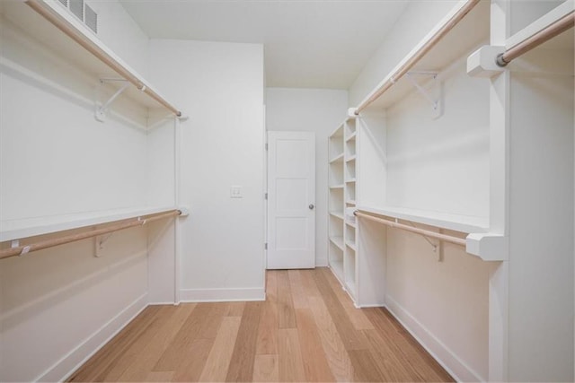 spacious closet featuring light hardwood / wood-style flooring