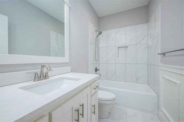 full bathroom with vanity, toilet, and tiled shower / bath