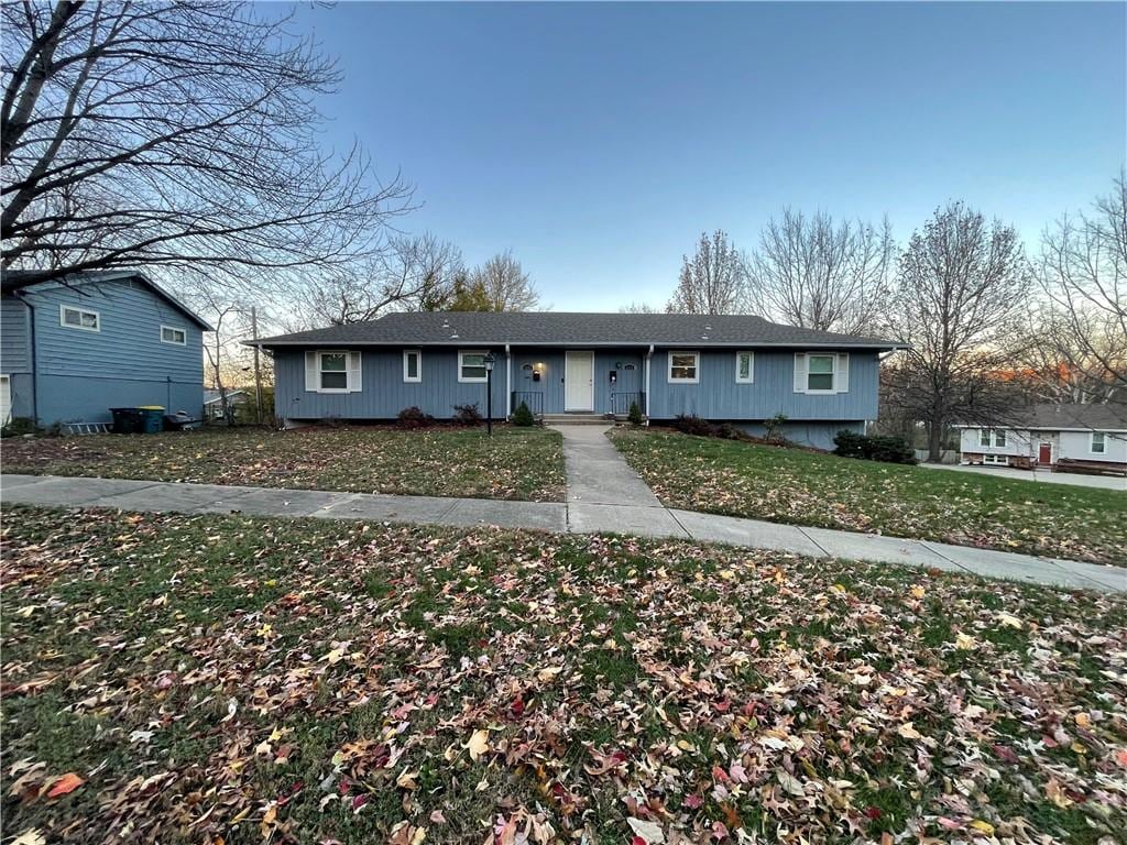 ranch-style house with a front lawn