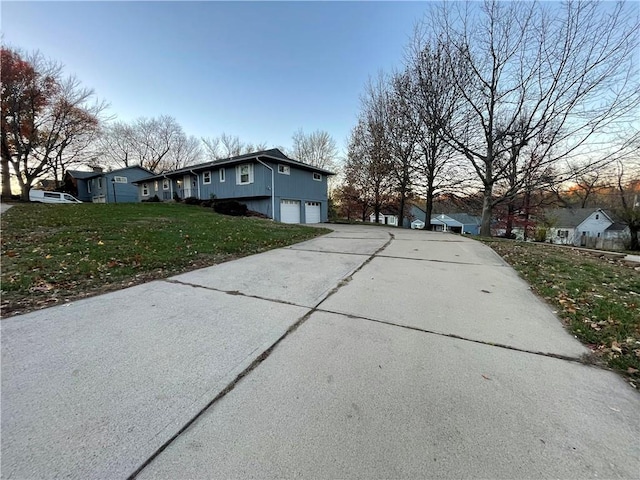 view of home's exterior featuring a lawn and a garage