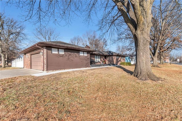 ranch-style home with a garage and a front lawn