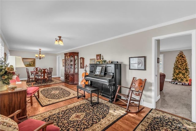 living room featuring hardwood / wood-style floors, ornamental molding, and a chandelier