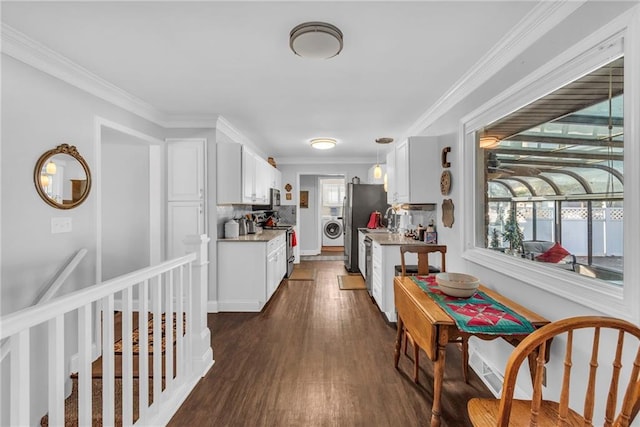 kitchen featuring white cabinetry, dark hardwood / wood-style flooring, washer / clothes dryer, crown molding, and appliances with stainless steel finishes