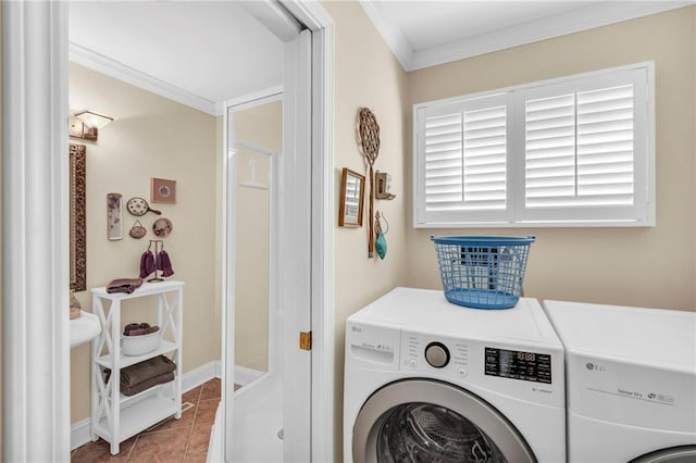 laundry room featuring washing machine and dryer, light tile patterned floors, and ornamental molding