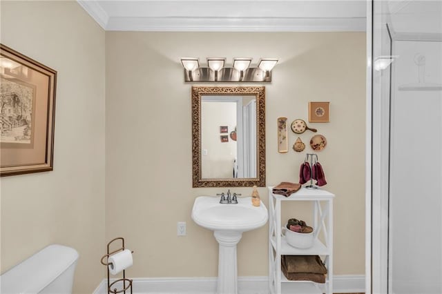 bathroom with crown molding and toilet