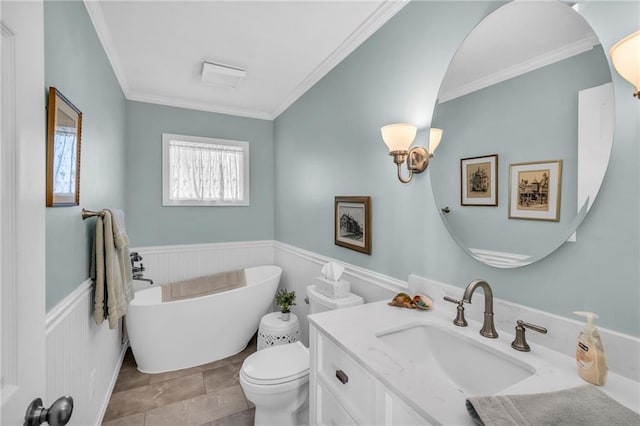 bathroom with a tub to relax in, toilet, vanity, and ornamental molding