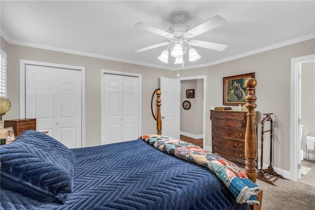 carpeted bedroom with ceiling fan, ornamental molding, and multiple closets