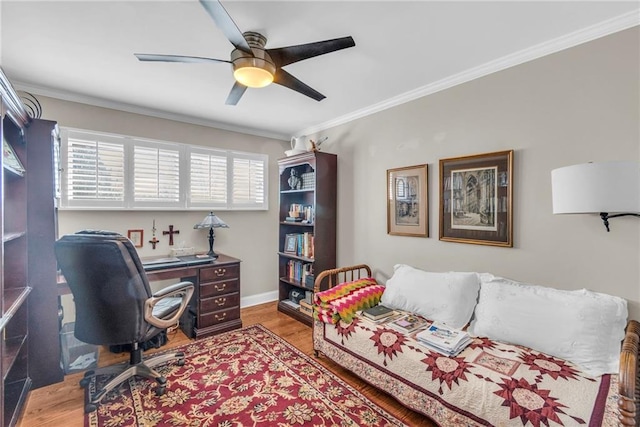 office featuring light wood-type flooring, ceiling fan, and ornamental molding