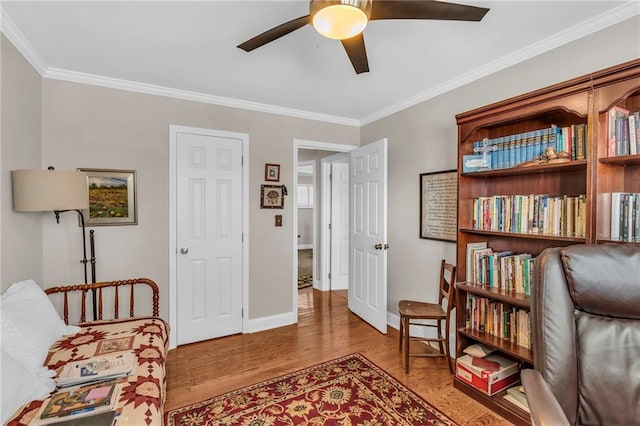 sitting room featuring hardwood / wood-style flooring, ceiling fan, and ornamental molding