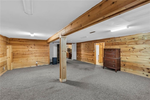 basement with carpet floors and wooden walls