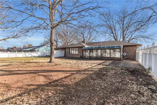 back of house featuring a sunroom and a patio area