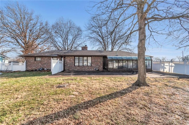 back of property with a lawn and a patio area