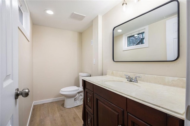 bathroom featuring vanity, toilet, and wood-type flooring