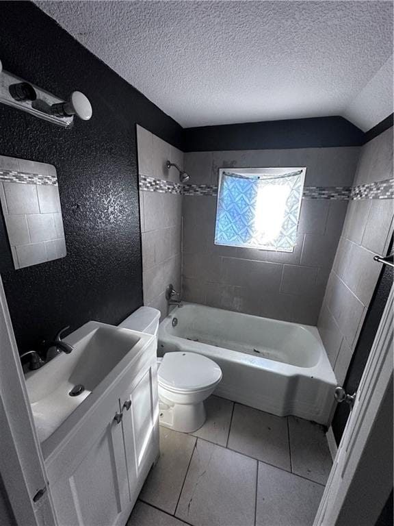 full bathroom with toilet, lofted ceiling, a textured ceiling, and tiled shower / bath