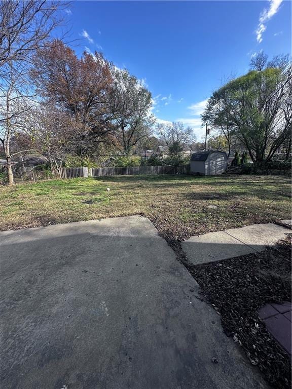 view of yard featuring a patio and a storage unit