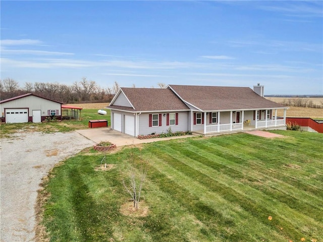 view of front of property featuring a porch, a garage, and a front yard