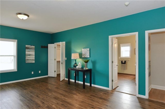 bedroom with dark wood-type flooring