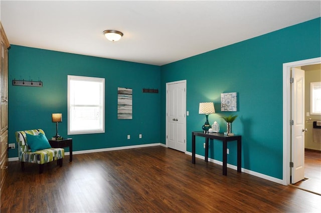 sitting room with dark hardwood / wood-style flooring