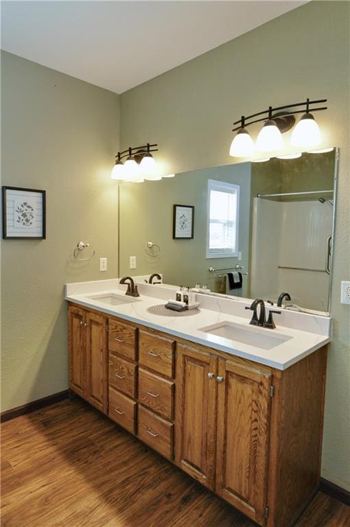 bathroom with vanity, hardwood / wood-style floors, and walk in shower