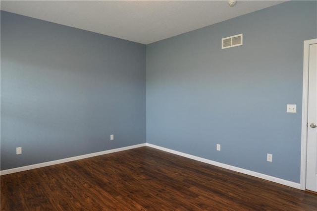 unfurnished room with hardwood / wood-style flooring