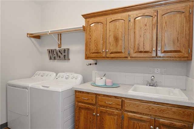 washroom featuring independent washer and dryer, cabinets, and sink