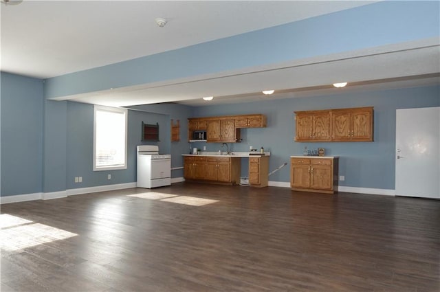 kitchen featuring sink, dark hardwood / wood-style floors, and white gas range oven