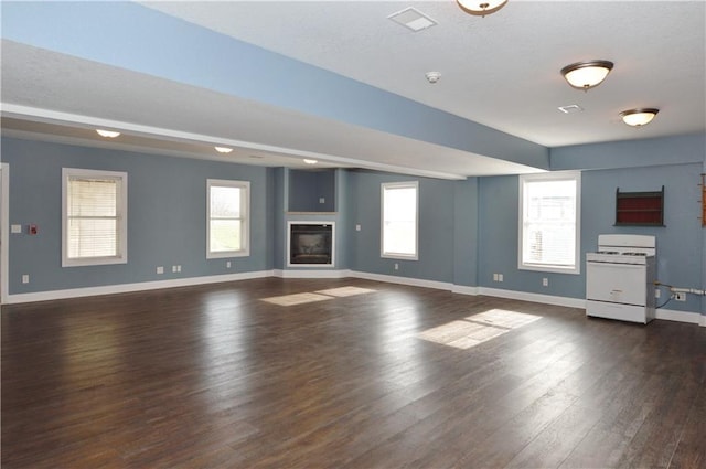 unfurnished living room featuring dark hardwood / wood-style floors