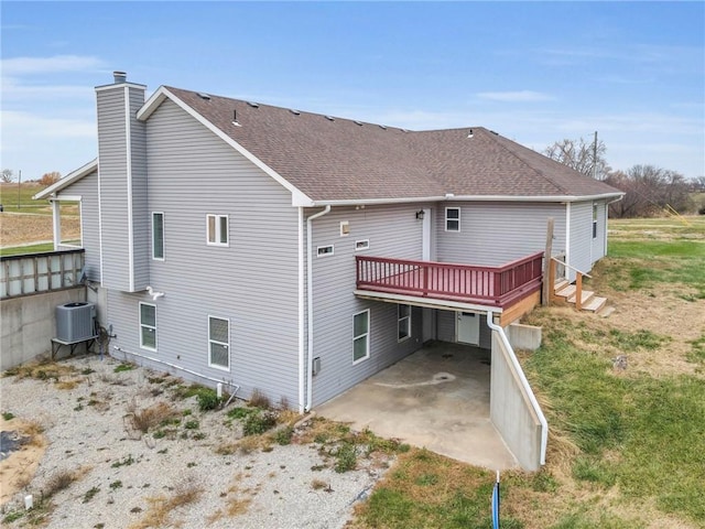 back of property with a deck, a patio, and central air condition unit