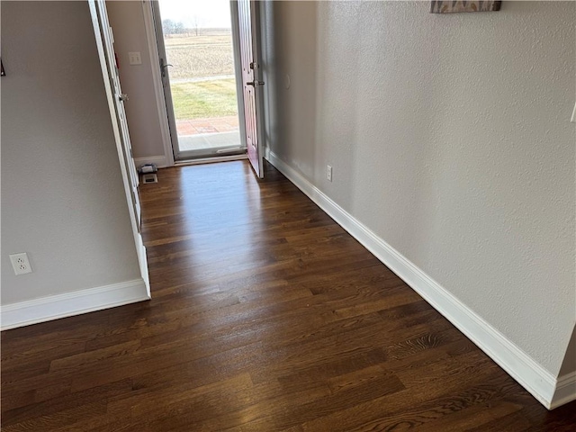 doorway to outside with dark wood-type flooring