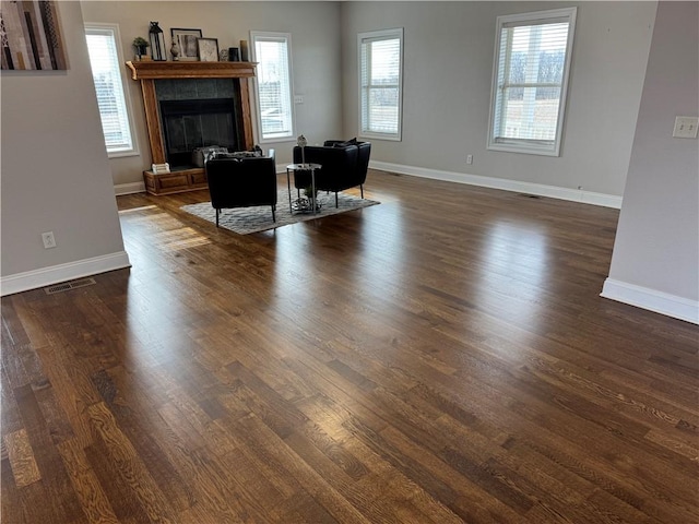 living room with a fireplace and dark hardwood / wood-style floors