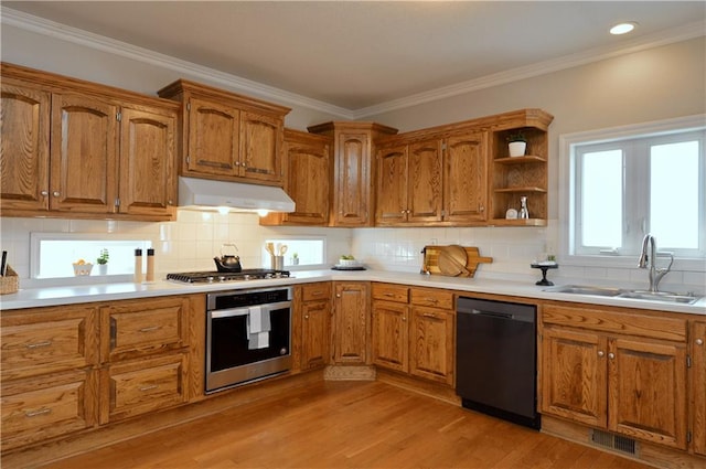 kitchen featuring sink, crown molding, appliances with stainless steel finishes, backsplash, and light wood-type flooring