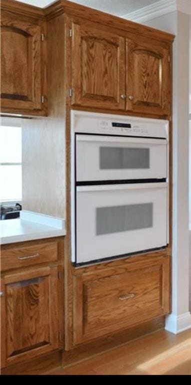 kitchen with ornamental molding and double oven