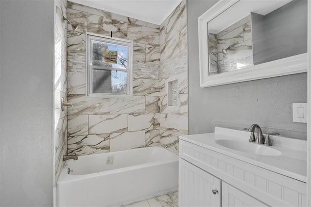 bathroom with vanity and tiled shower / bath combo