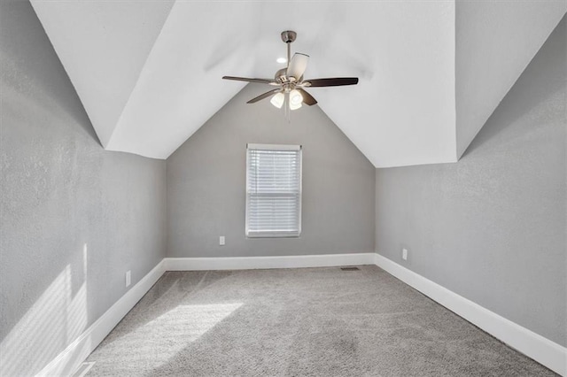 bonus room featuring ceiling fan, light colored carpet, and lofted ceiling