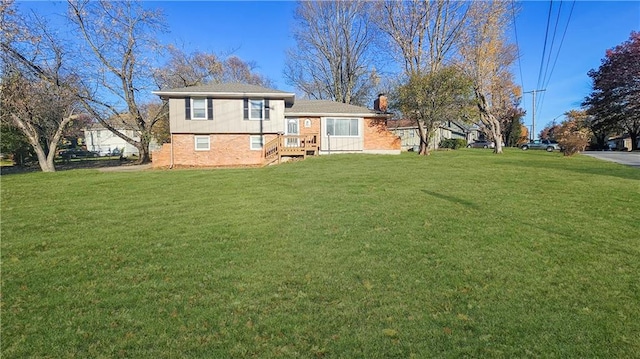 back of house with a lawn