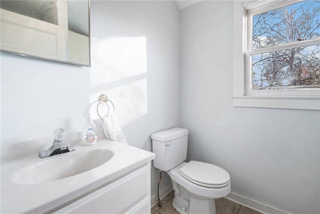 bathroom featuring tile patterned floors, vanity, and toilet