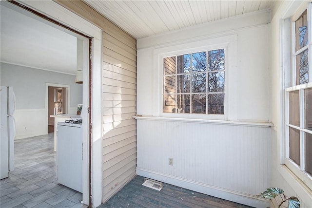 unfurnished sunroom with wooden ceiling