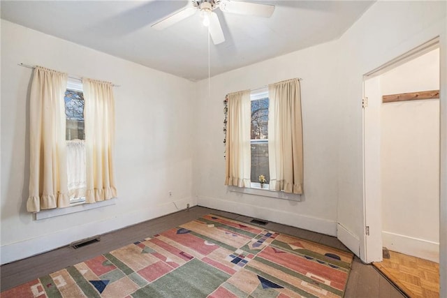 unfurnished room featuring ceiling fan and wood-type flooring