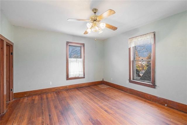 unfurnished room with hardwood / wood-style floors and ceiling fan