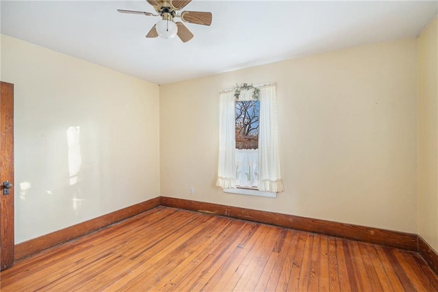 empty room with wood-type flooring and ceiling fan