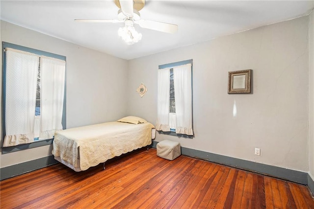 bedroom with ceiling fan and dark hardwood / wood-style floors