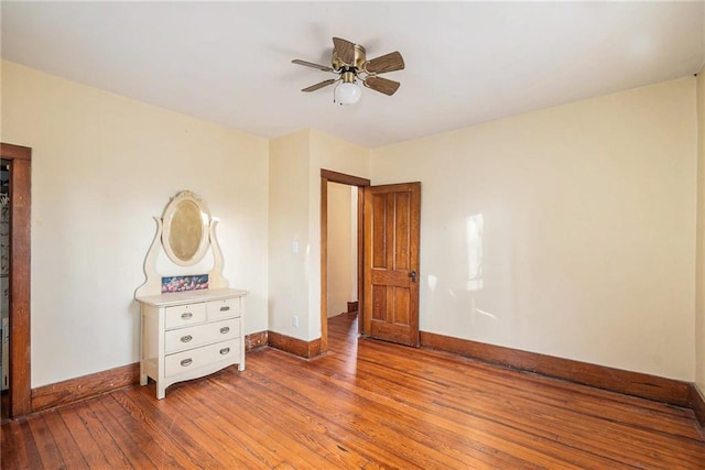 unfurnished bedroom with baseboards, ceiling fan, and hardwood / wood-style floors