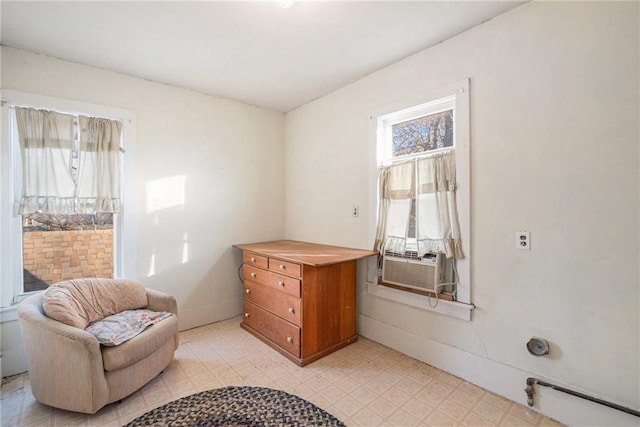 sitting room featuring cooling unit and light floors
