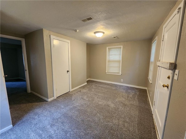 unfurnished bedroom with carpet flooring, a closet, and a textured ceiling