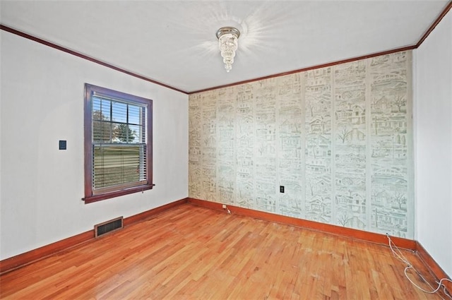 unfurnished room with wood-type flooring and crown molding