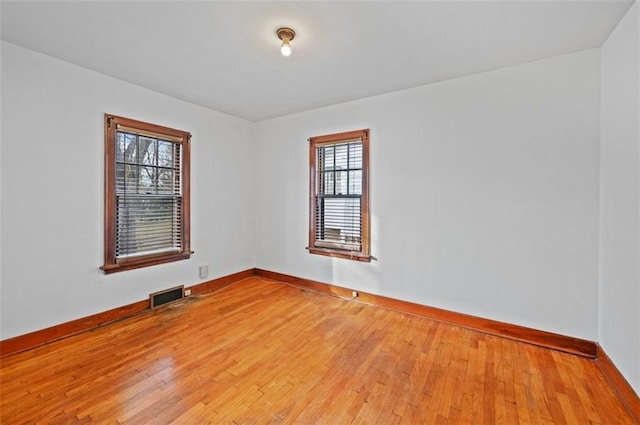 spare room featuring light hardwood / wood-style floors