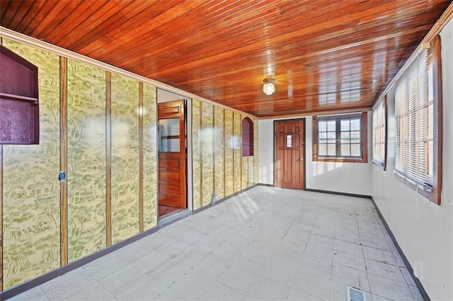 unfurnished sunroom with wood ceiling