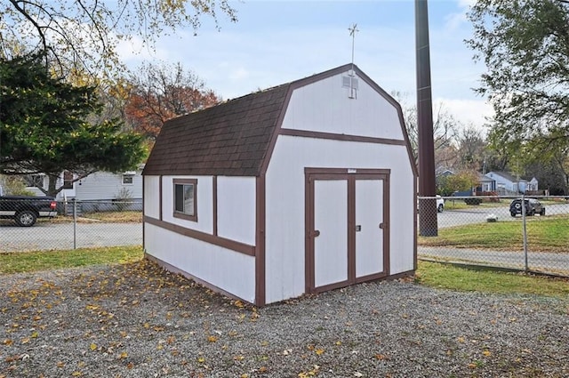 view of shed featuring fence