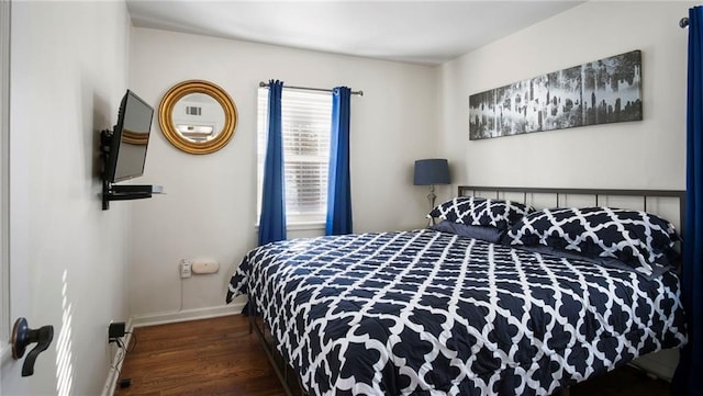 bedroom with dark hardwood / wood-style floors