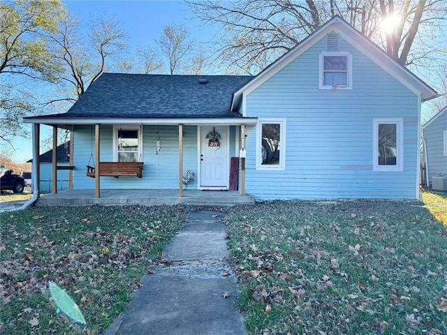 view of front of property featuring covered porch and cooling unit